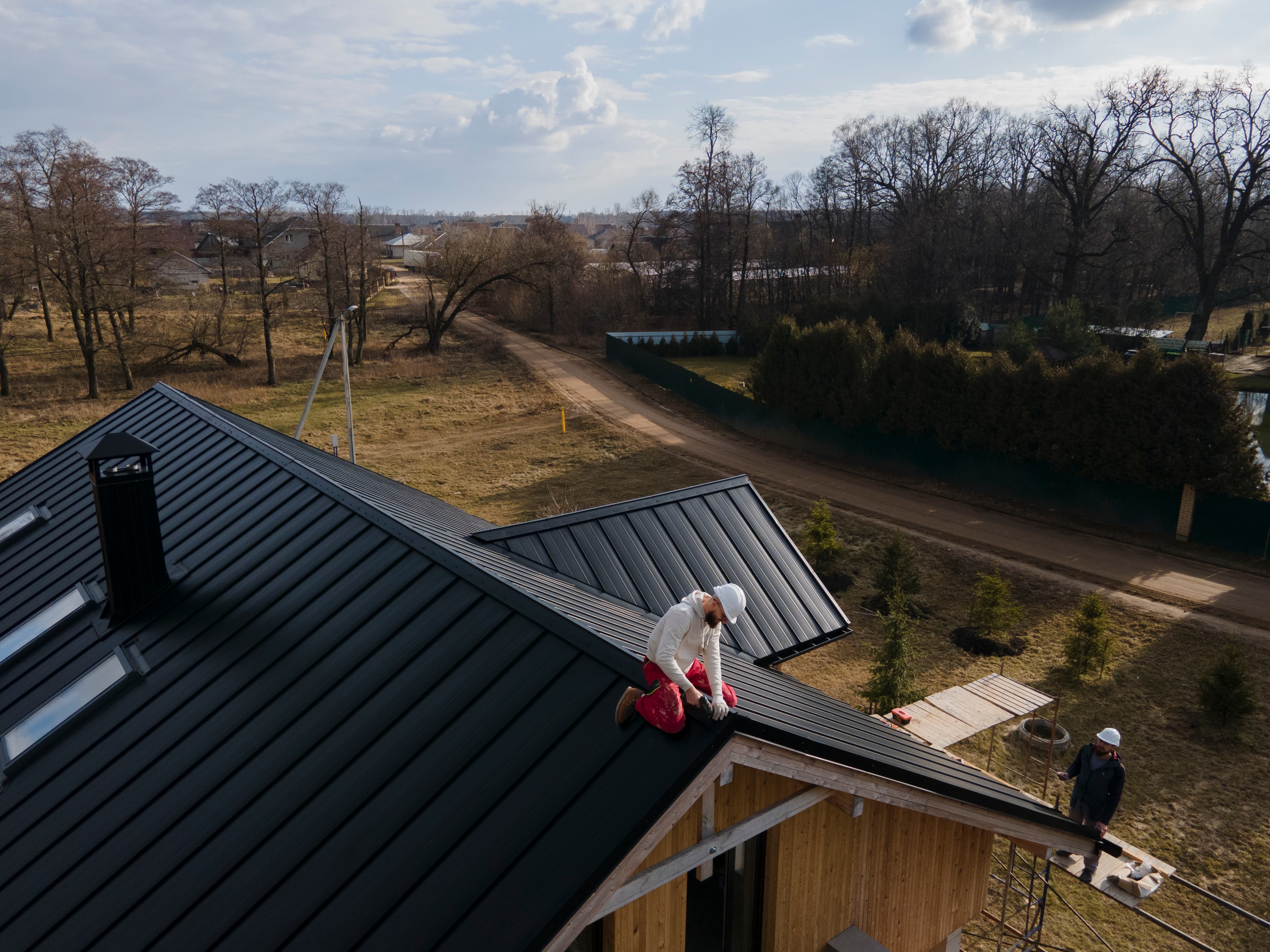Professional roofer installing shingles on a residential roof